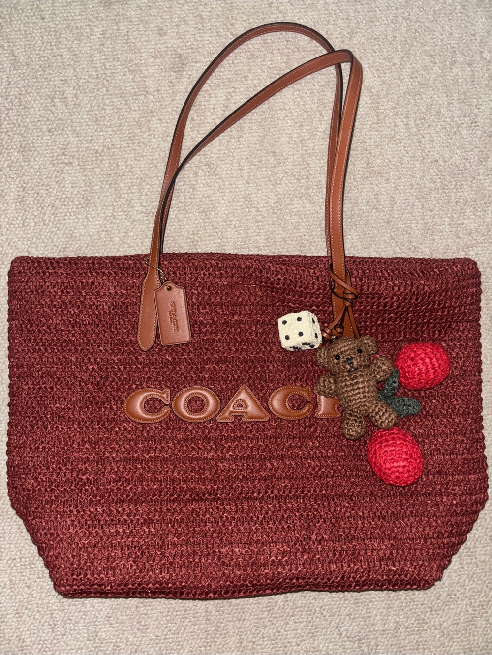 COACH straw tote with charms